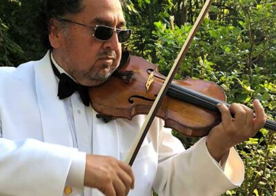 Wilson Pedrazas playing violin in the woods